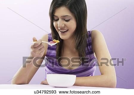Woman eating breakfast View Large Photo Image Stock Image - Woman eating breakfast . Fotosearch