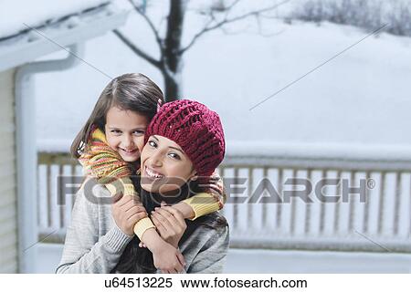 Stock Photography - Woman giving girl piggy back ride . Fotosearch