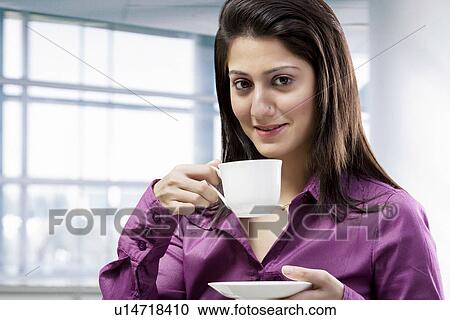 Stock Image - Woman having a cup of coffee . Fotosearch