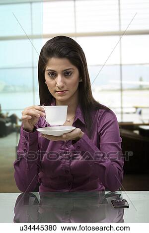 Woman having a cup of coffee View Large Photo Image Stock Image - Woman having a cup of coffee . Fotosearch