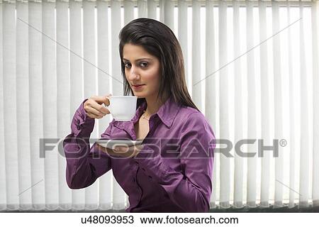 Woman having a cup of coffee View Large Photo Image Stock Image - Woman having a cup of coffee . Fotosearch