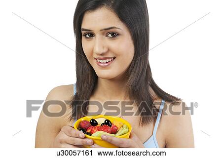 Woman holding a bowl of fruits View Large Photo Image Stock Image - Woman holding a bowl of fruits . Fotosearch
