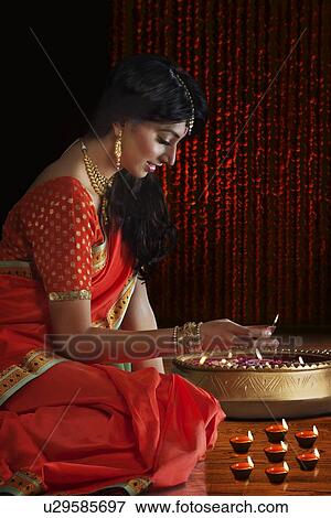 Woman holding a diya View Large Photo Image Stock Photo - Woman holding a diya. Fotosearch
