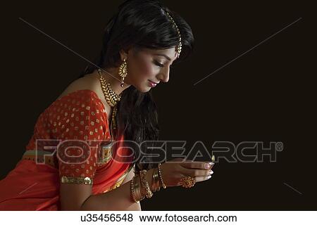Woman holding a diya View Large Photo Image Stock Photo - Woman holding a diya. Fotosearch
