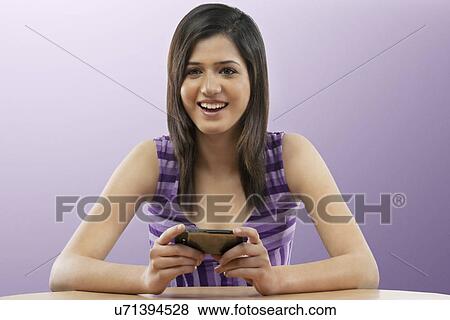 Stock Photo - Woman holding a mobile phone . Fotosearch