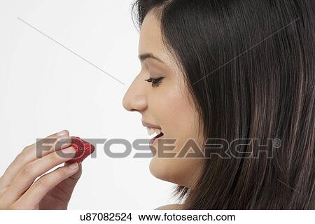 Woman holding a strawberry View Large Photo Image Picture - Woman holding a strawberry . Fotosearch