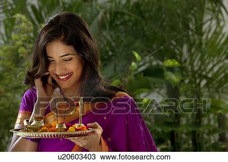 Stock Image - Woman holding a tray . Fotosearch