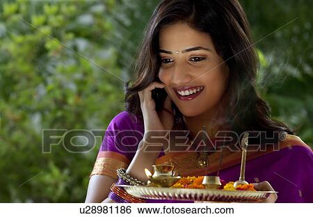 Woman holding a tray View Large Photo Image Stock Photograph - Woman holding a tray . Fotosearch