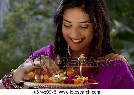Woman holding a tray View Large Photo Image Stock Photograph - Woman holding a tray . Fotosearch