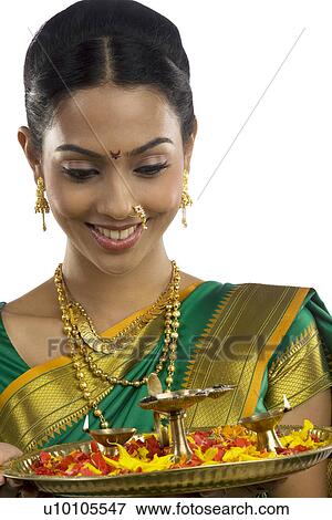 Woman holding a tray with diyas View Large Photo Image Stock Photo - Woman holding a tray with diyas . Fotosearch