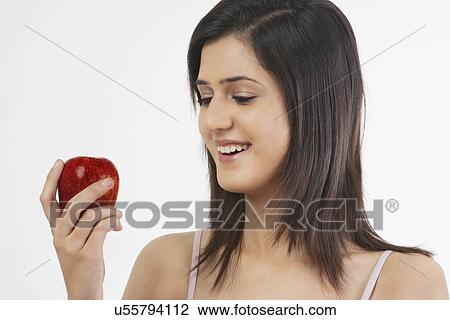 Woman holding an apple View Large Photo Image Stock Image - Woman holding an apple . Fotosearch