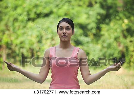 Woman in lawn practicing yoga and looking away View Large Photo Image Stock Image - Woman in lawn practicing yoga and looking away . Fotosearch