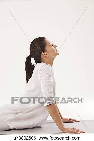 Woman in upward facing dog position over white background View Large Photo Image Stock Photograph - Woman in upward facing dog position over white background . Fotosearch