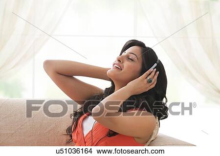 Picture - Woman listening to music. Fotosearch