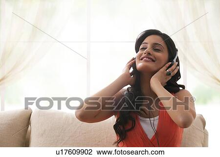 Woman listening to music View Large Photo Image Stock Image - Woman listening to music. Fotosearch