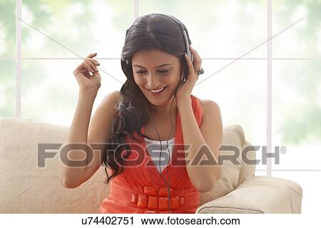 Woman listening to music View Large Photo Image Stock Image - Woman listening to music. Fotosearch