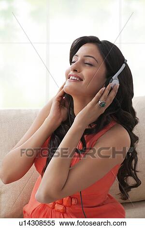Woman listening to music View Large Photo Image Stock Photography - Woman listening to music. Fotosearch