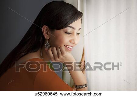 Woman looking out of a window View Large Photo Image Stock Photography - Woman looking out of a window . Fotosearch