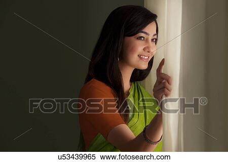 Stock Photography - Woman looking out of a window . Fotosearch
