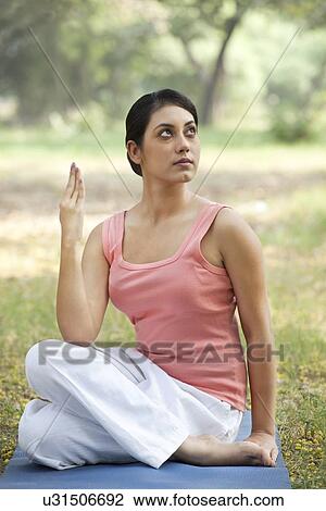 Stock Image - Woman looking up while exercising . Fotosearch