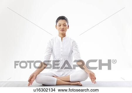 Picture - Woman meditating over white background . Fotosearch