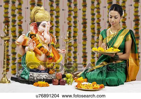 Woman performing a pooja View Large Photo Image Picture - Woman performing a pooja . Fotosearch
