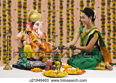 Woman performing a pooja View Large Photo Image Stock Image - Woman performing a pooja . Fotosearch