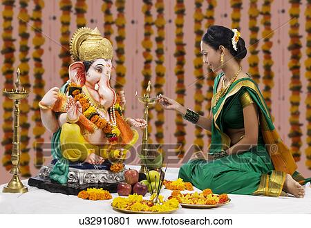 Woman performing a pooja View Large Photo Image Stock Image - Woman performing a pooja . Fotosearch