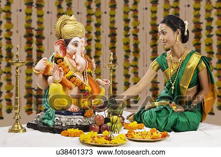 Woman performing a pooja View Large Photo Image Stock Image - Woman performing a pooja . Fotosearch
