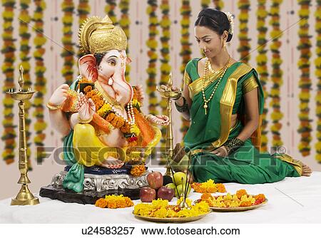Stock Photo - Woman performing a pooja . Fotosearch