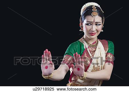 Stock Photography - Woman performing Bharatanatyam over black background. Fotosearch