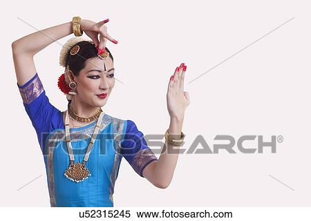 Stock Photography - Woman performing Bharatanatyam the classical dance of India on white background. Fotosearch