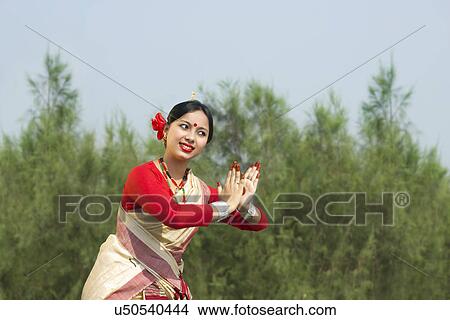 Picture - Woman performing Bihu dance . Fotosearch