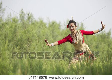 Stock Photograph - Woman performing Bihu dance . Fotosearch