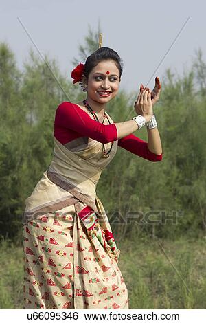 Stock Photograph - Woman performing Bihu dance . Fotosearch