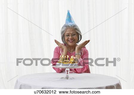 Woman posing with her birthday cake View Large Photo Image Stock Image - Woman posing with her birthday cake. Fotosearch