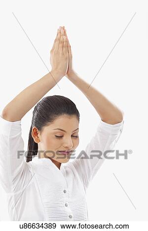 Woman practicing yoga with arms raised View Large Photo Image Stock Photo - Woman practicing yoga with arms raised . Fotosearch