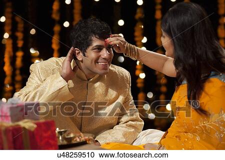 Woman putting tika on a man View Large Photo Image Stock Image - Woman putting tika on a man. Fotosearch