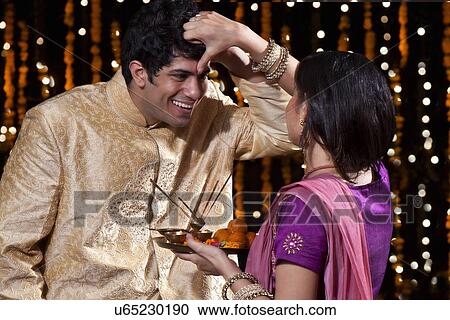 Woman putting tika on a man View Large Photo Image Stock Image - Woman putting tika on a man. Fotosearch