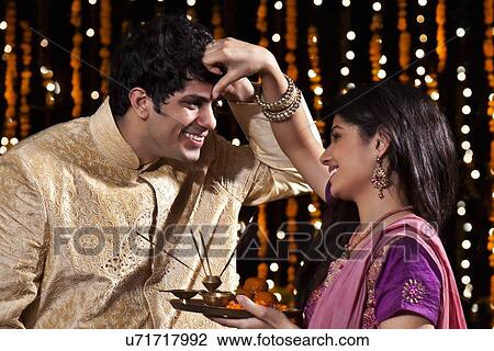 Woman putting tika on a man View Large Photo Image Stock Image - Woman putting tika on a man. Fotosearch