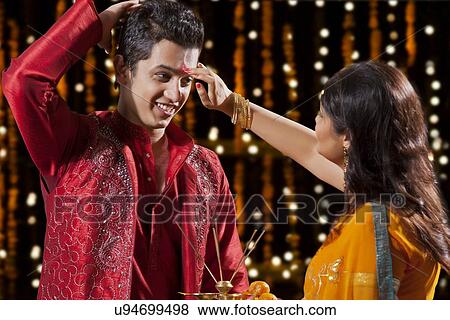 Woman putting tika on a man View Large Photo Image Stock Photo - Woman putting tika on a man. Fotosearch