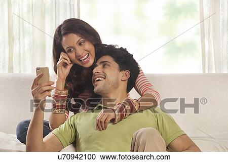 Woman reading an sms on a mobile phone View Large Photo Image Stock Image - Woman reading an sms on a mobile phone. Fotosearch