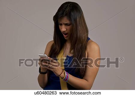 Woman reading an sms on her phone View Large Photo Image Stock Image - Woman reading an sms on her phone . Fotosearch