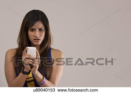 Woman reading an sms on her phone View Large Photo Image Stock Image - Woman reading an sms on her phone . Fotosearch