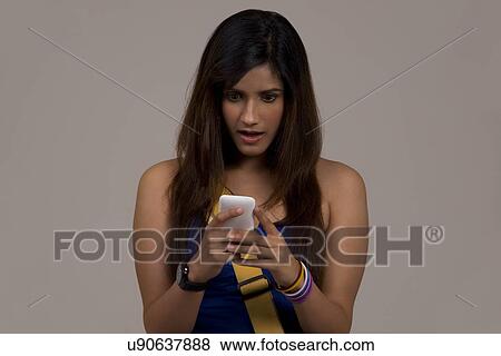 Stock Photo - Woman reading an sms on her phone . Fotosearch