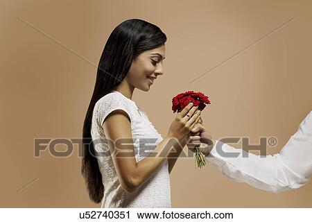 Woman receiving flowers from a man View Large Photo Image Stock Image - Woman receiving flowers from a man . Fotosearch