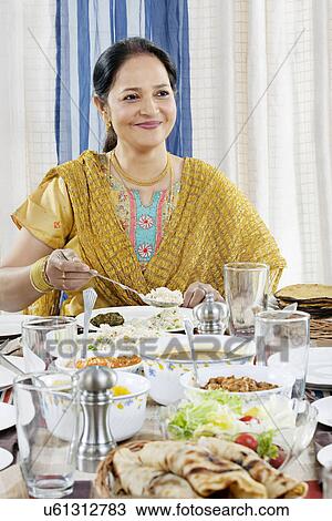 Woman serving herself some food View Large Photo Image Stock Image - Woman serving herself some food . Fotosearch