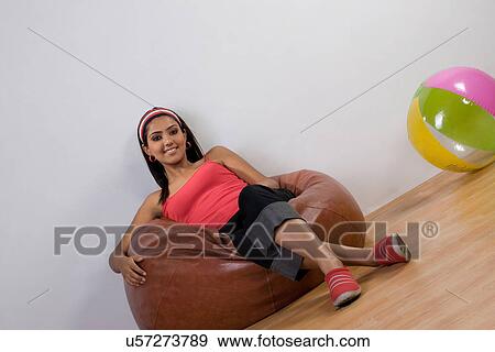 Woman sitting on a bean bag View Large Photo Image Stock Photo - Woman sitting on a bean bag . Fotosearch