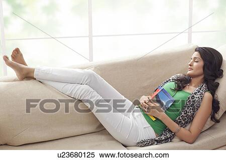 Stock Photography - Woman sleeping on a sofa. Fotosearch