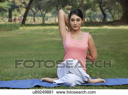 Woman stretching her arms in a yoga View Large Photo Image Stock Image - Woman stretching her arms in a yoga . Fotosearch